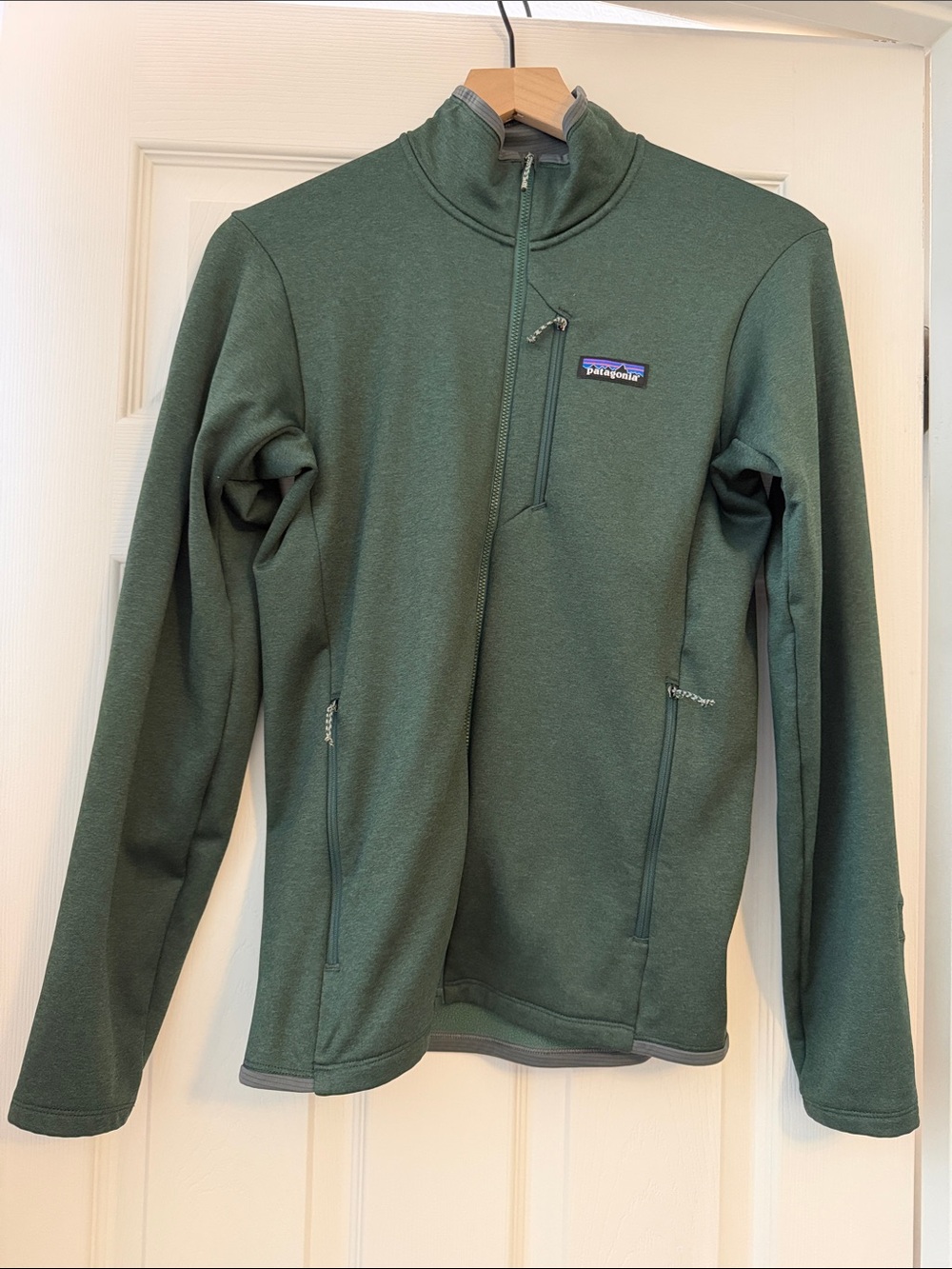 Patagonia Women’s Zip Up Green Jacket with multiple zippers high neck